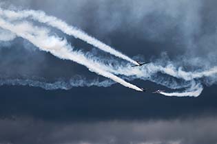 Dramatic skies in Kent form the backdrop to a Yak display team, Biggin Hill, June 2014